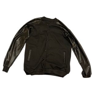 Black button up jacket. The arms are leather.